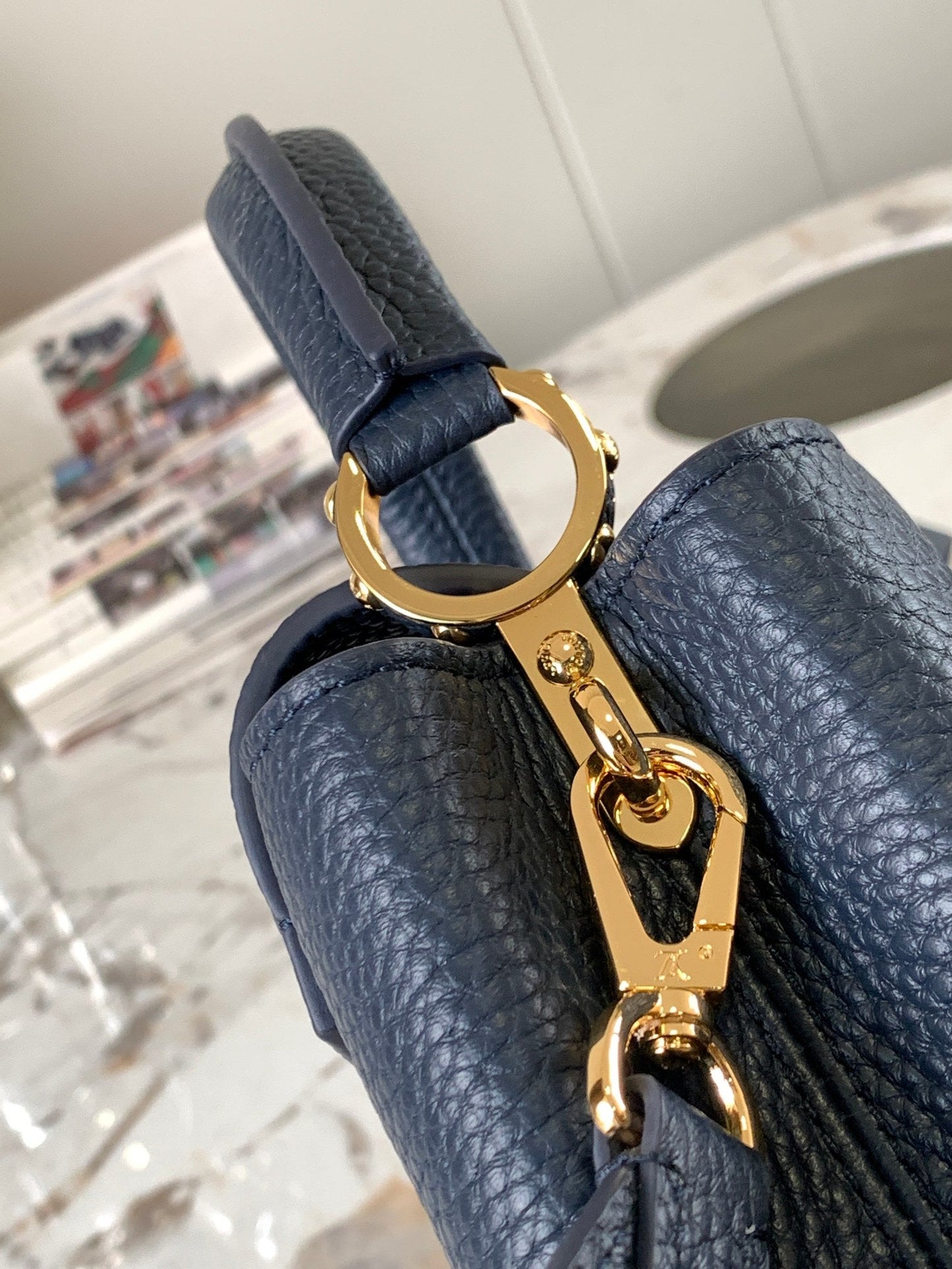 capucines mini 21 midnight blue taurillon leather gold hardware