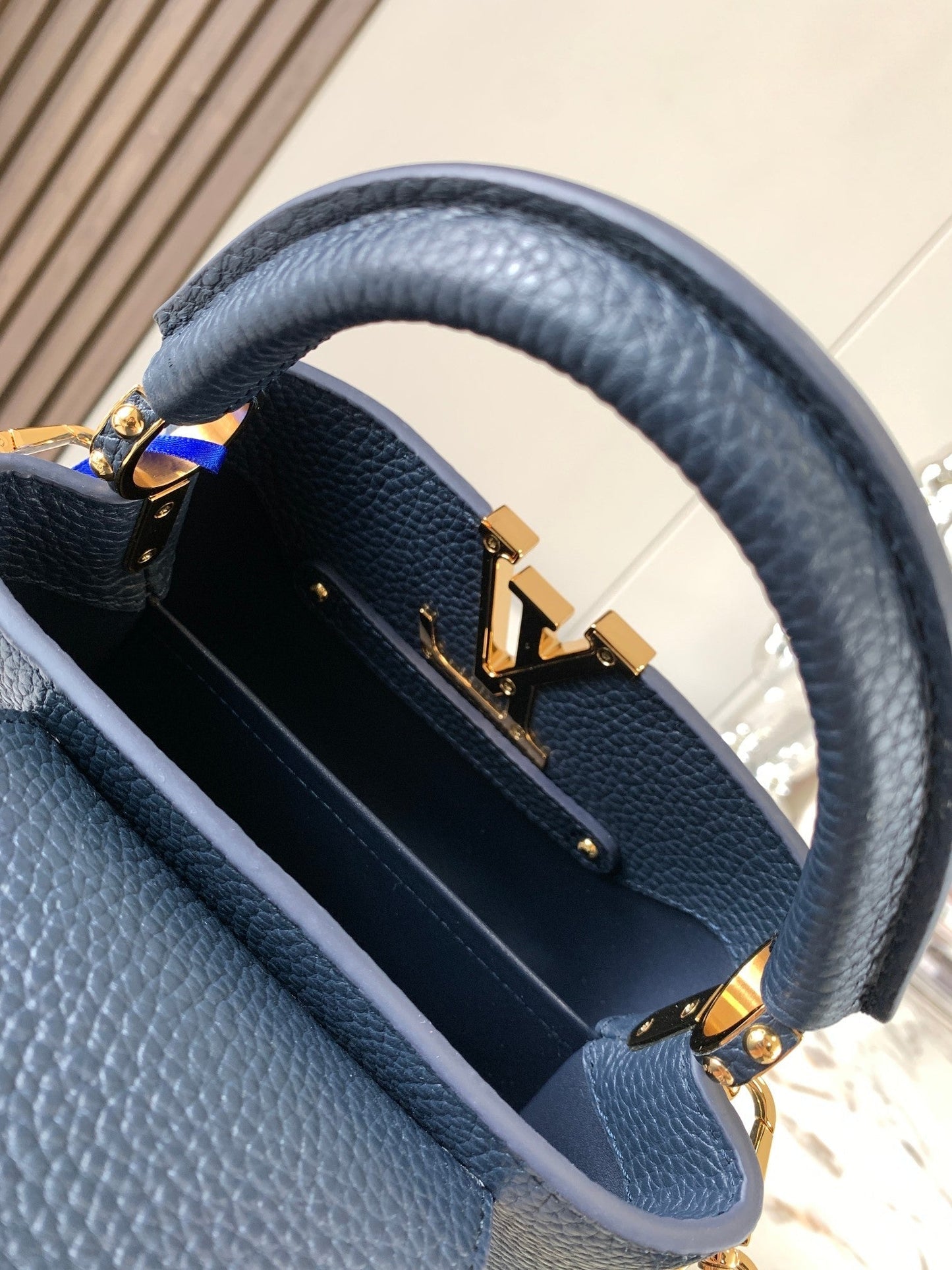 capucines mini 21 midnight blue taurillon leather gold hardware