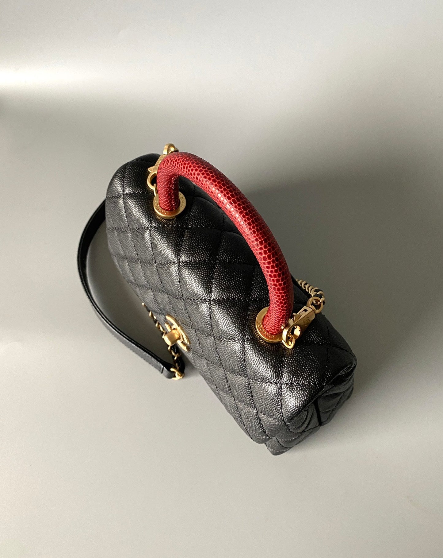 coco handle flap bag 23cm black quilted caviar with red top handle