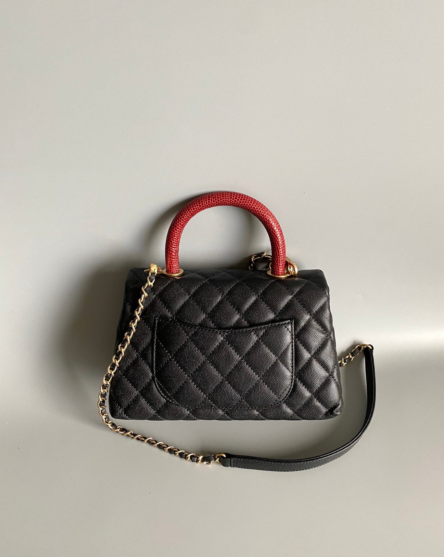 coco handle flap bag 23cm black quilted caviar with red top handle