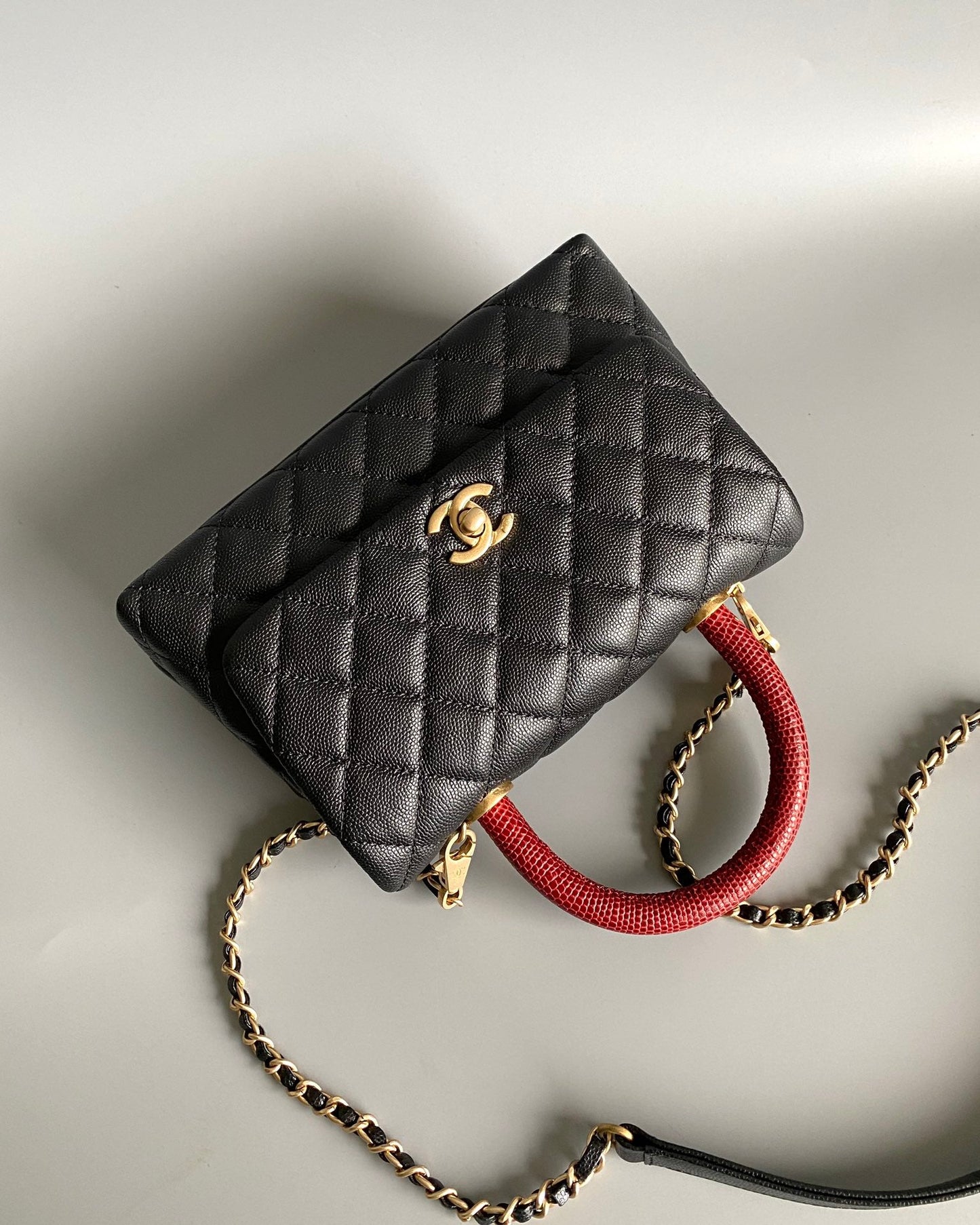 coco handle flap bag 23cm black quilted caviar with red top handle