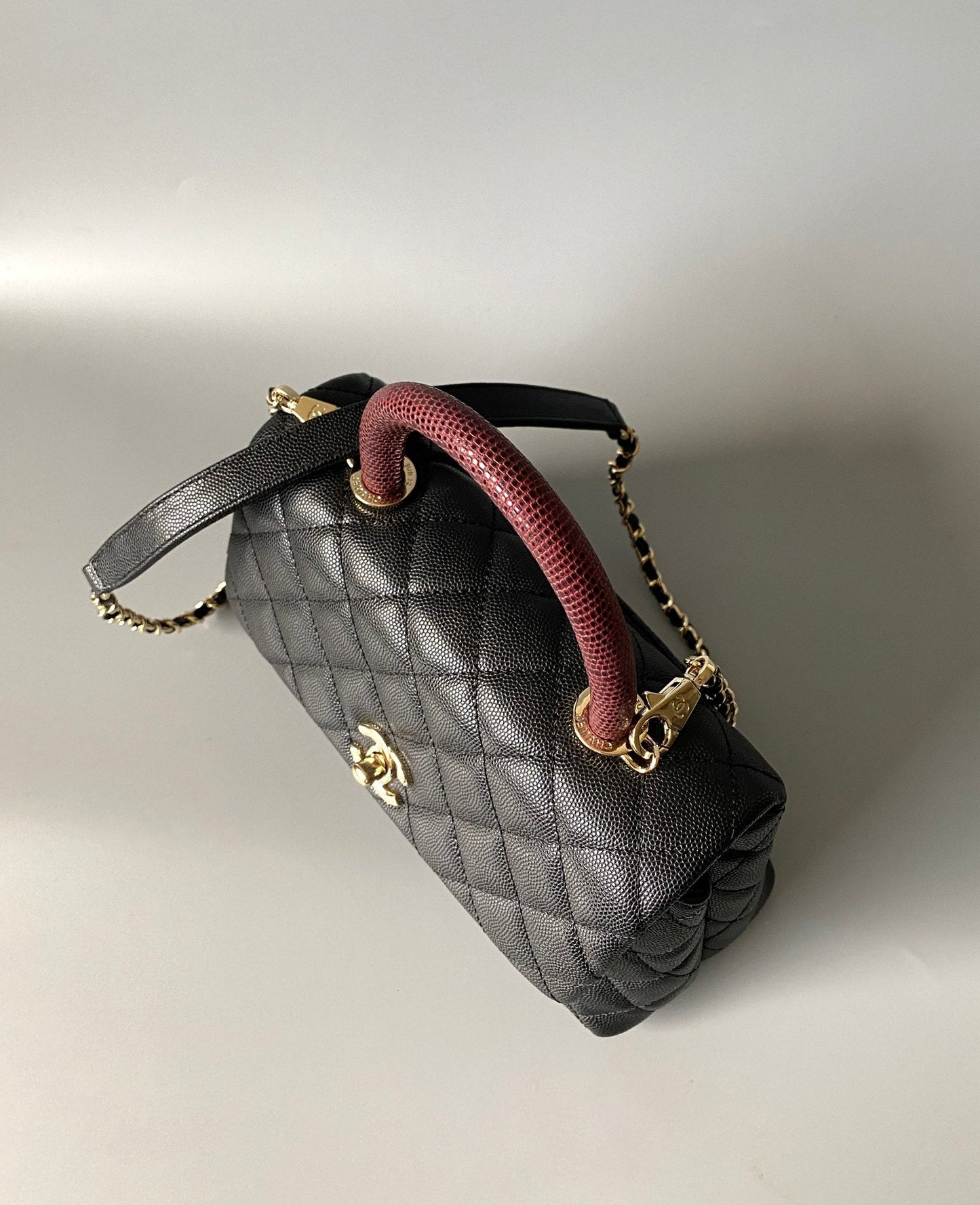 coco handle flap bag 23cm black quilted caviar with dark red top handle