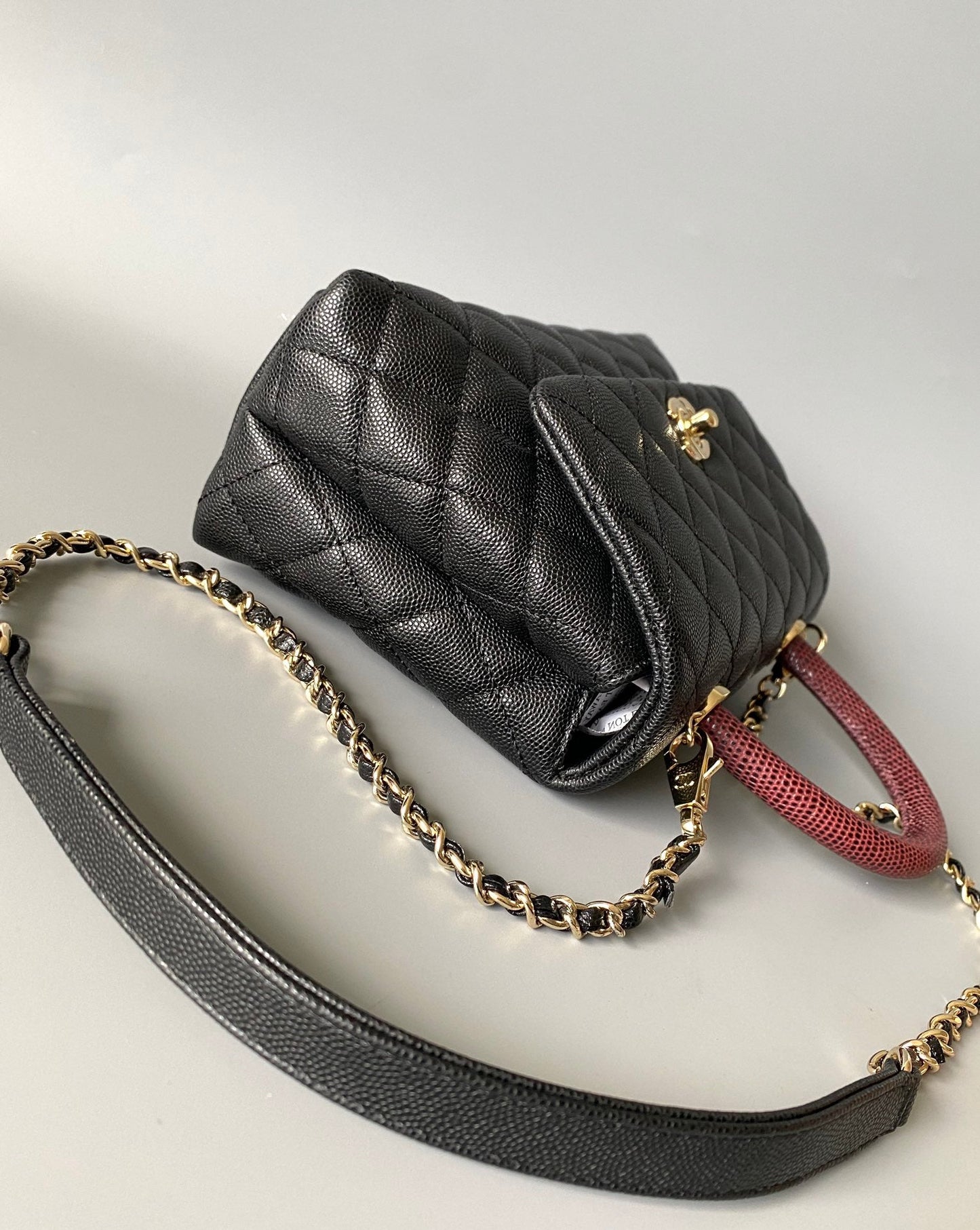 coco handle flap bag 23cm black quilted caviar with dark red top handle