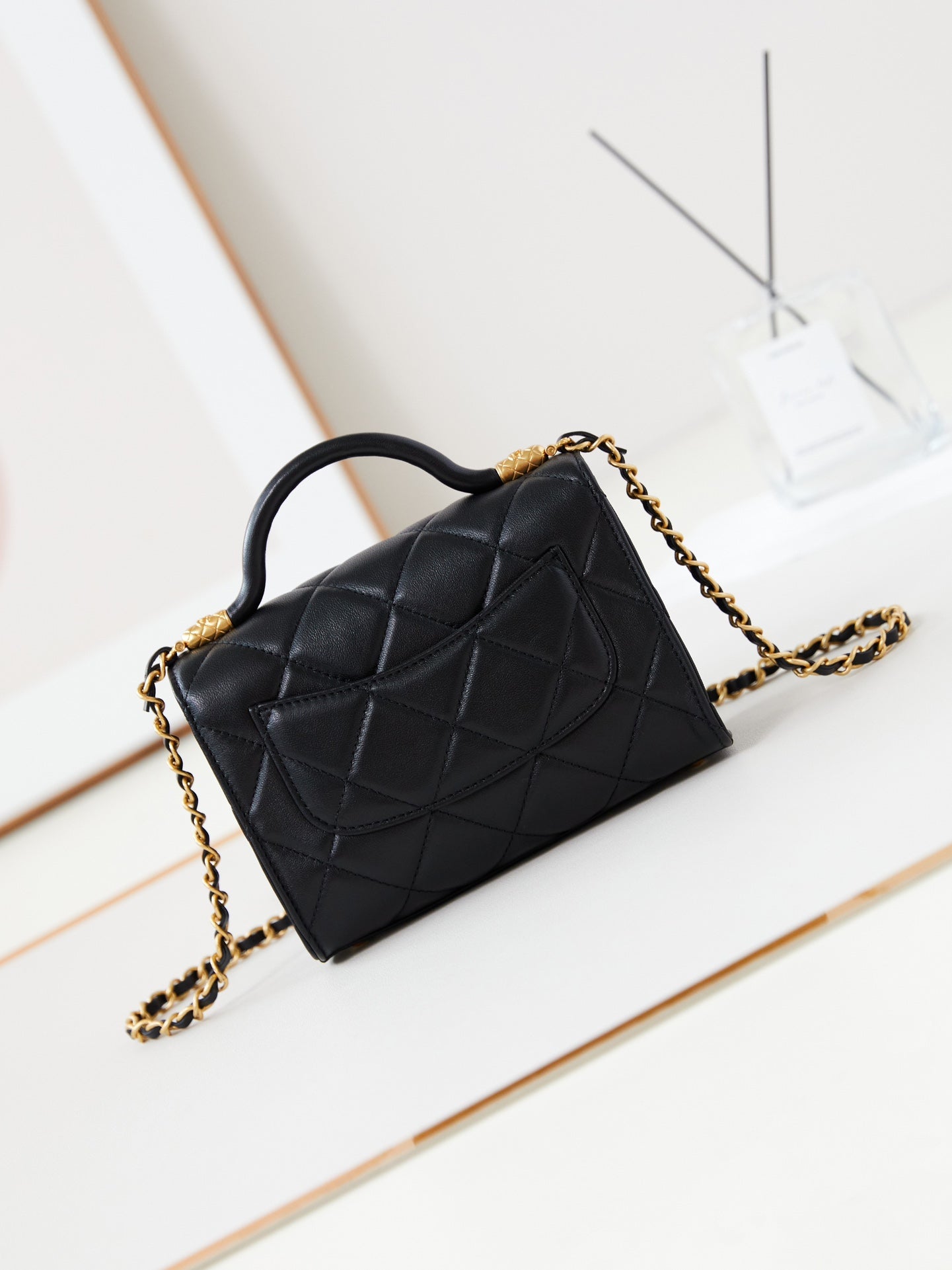 24a flap bag with top handle 18cm black lambskin gold hardware