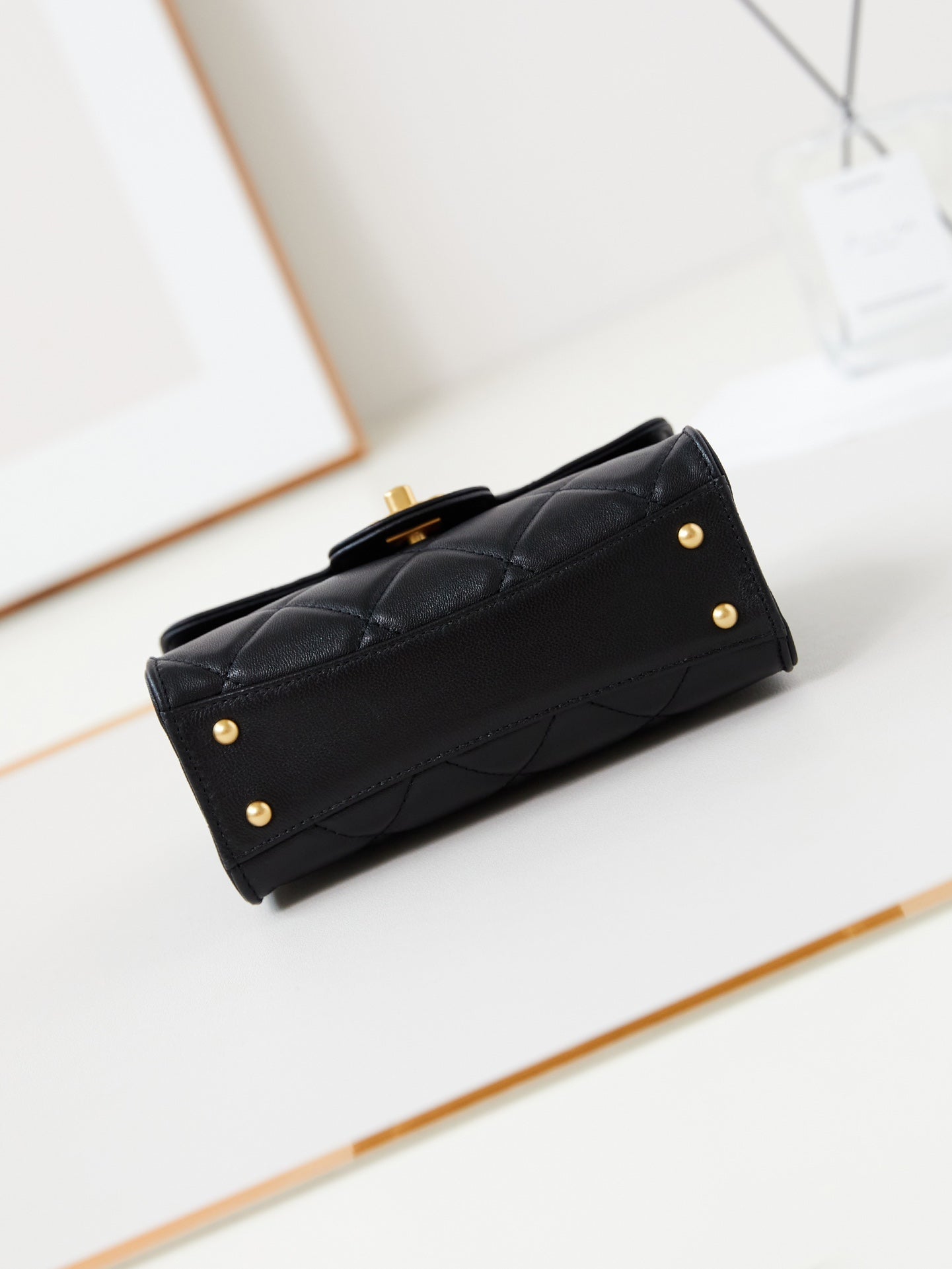 24a flap bag with top handle 18cm black lambskin gold hardware