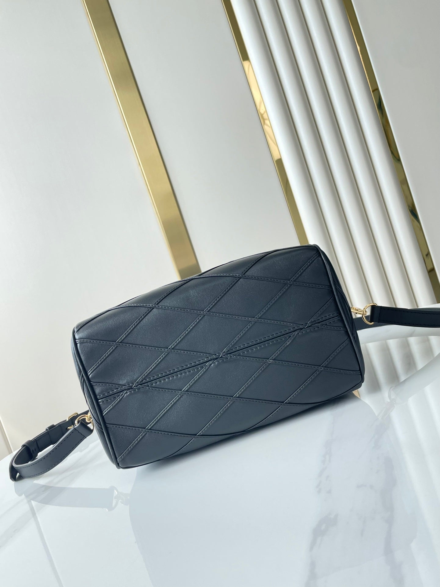 SPEEDY BANDOULIÈRE 25 WITH CRISS CROSS PATTERN IN BLACK LAMBSKIN