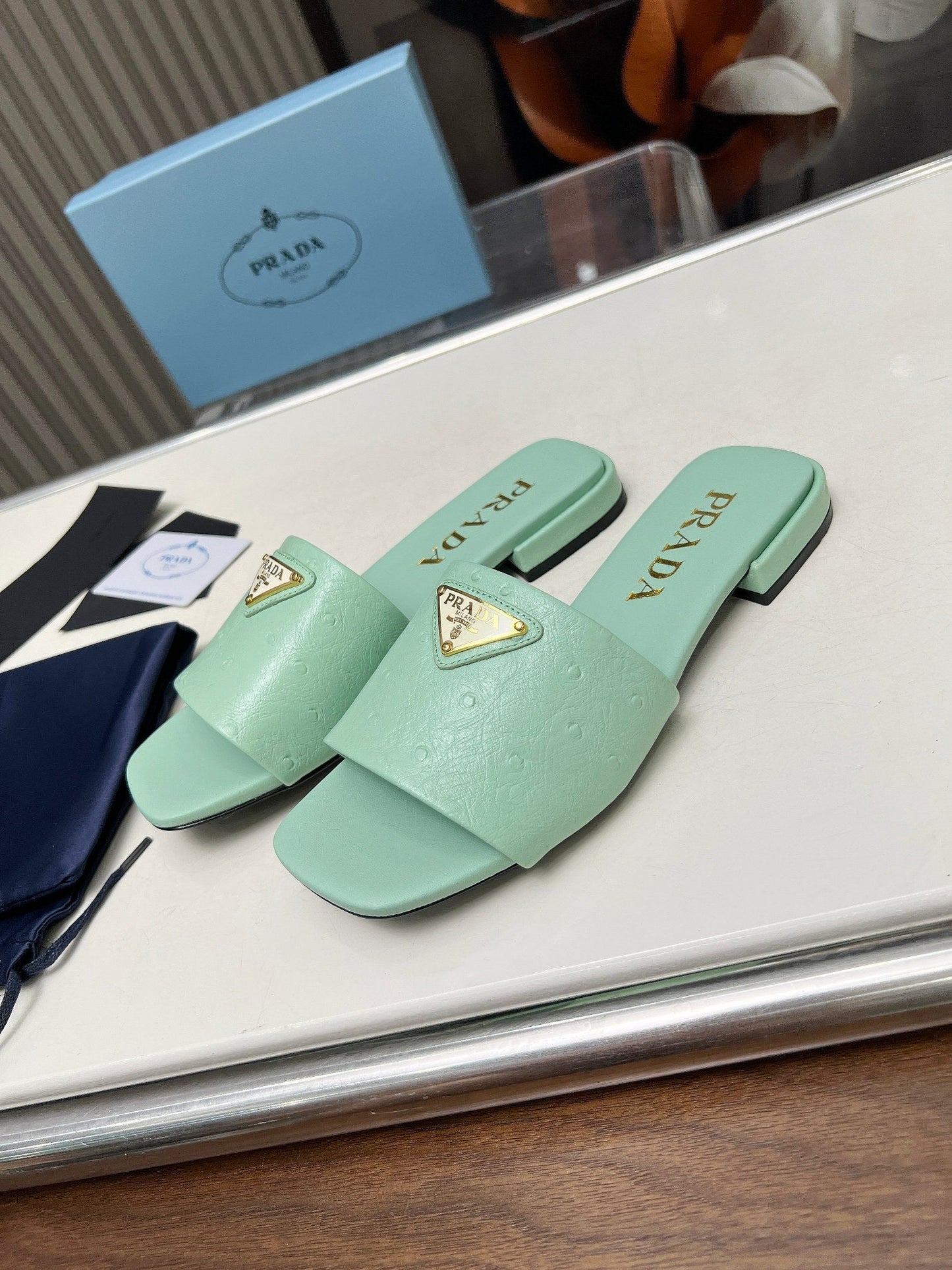 PRA SAFFIANO PATENT SLIDES OSTRICH MOTIF SEAFOAM CALFSKIN