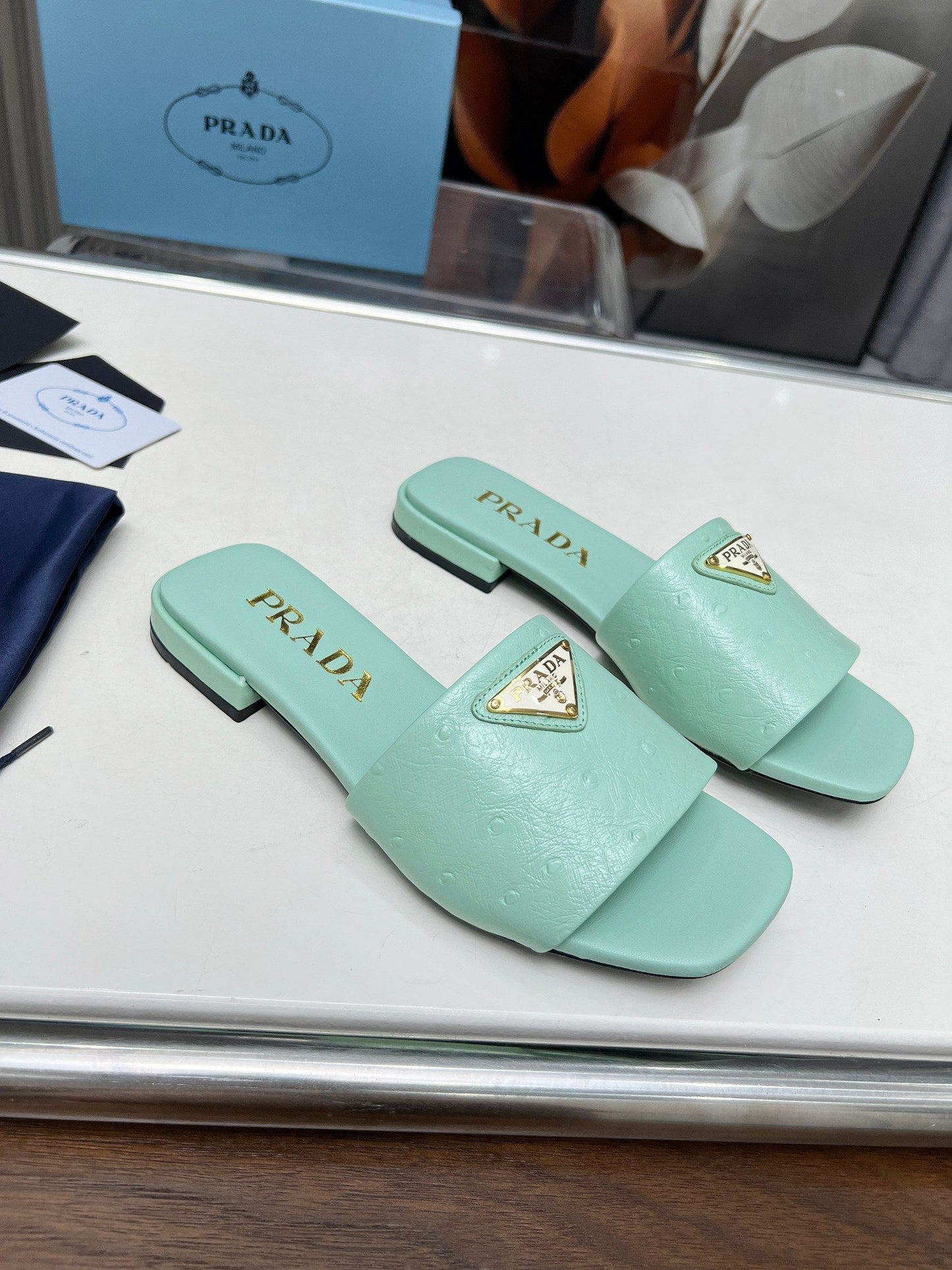 PRA SAFFIANO PATENT SLIDES OSTRICH MOTIF SEAFOAM CALFSKIN