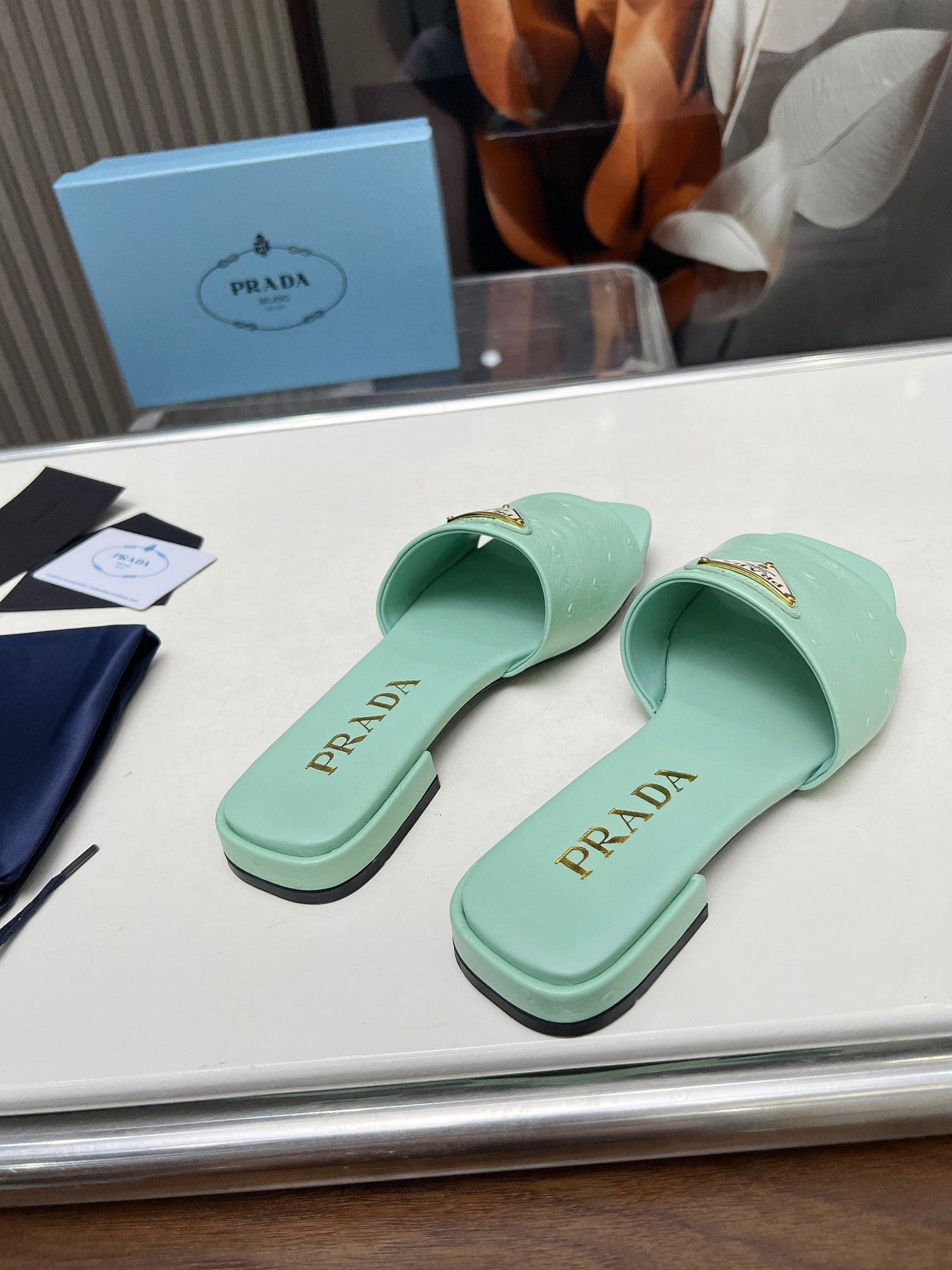 PRA SAFFIANO PATENT SLIDES OSTRICH MOTIF SEAFOAM CALFSKIN