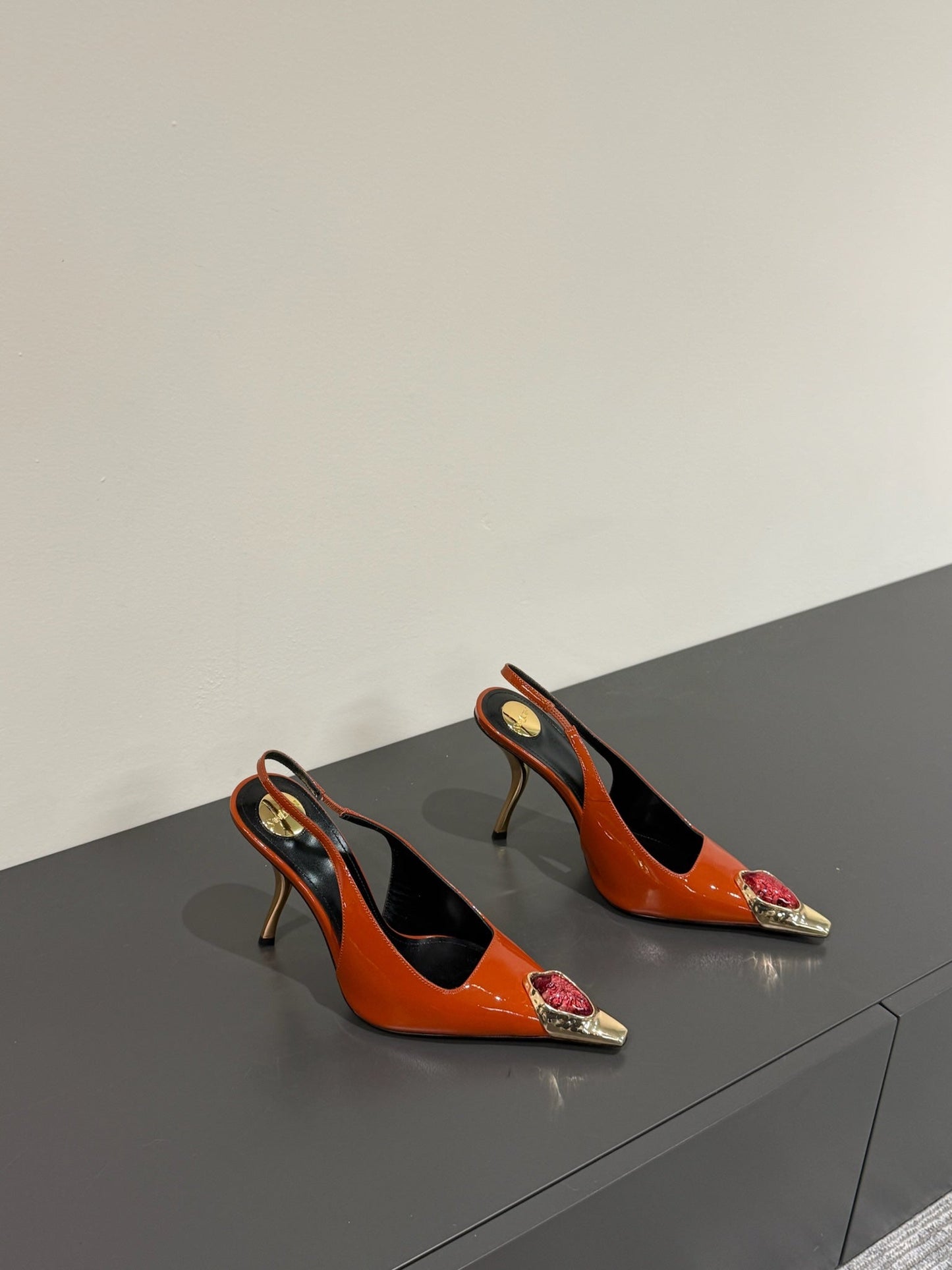 RED GEM-STUDDED SLINGBACK PUMPS IN ORANGE PATENT CALFSKIN