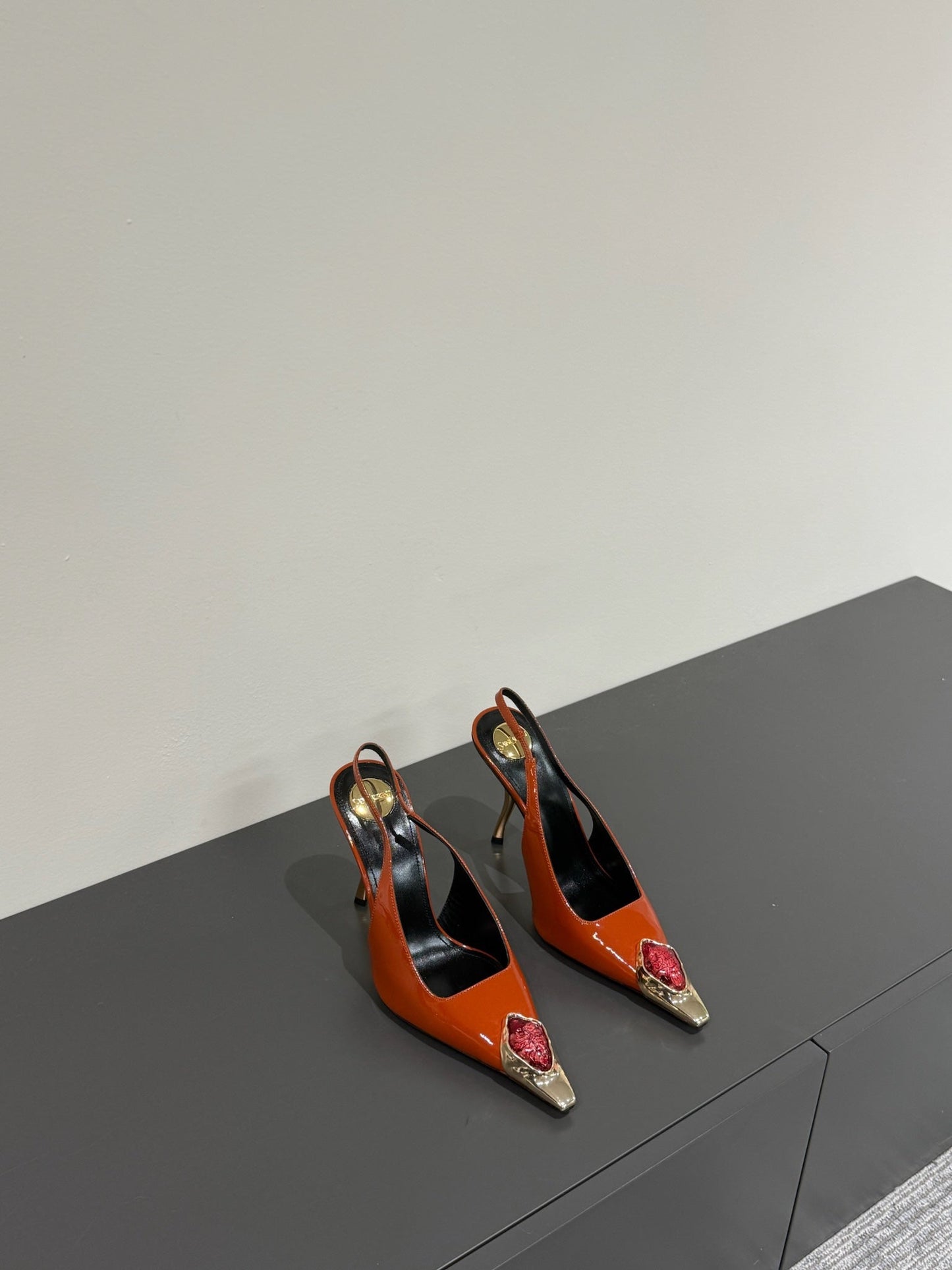 RED GEM-STUDDED SLINGBACK PUMPS IN ORANGE PATENT CALFSKIN