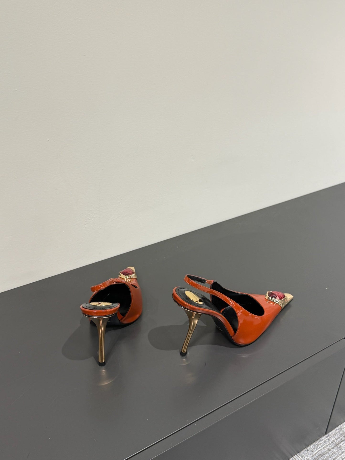 RED GEM-STUDDED SLINGBACK PUMPS IN ORANGE PATENT CALFSKIN