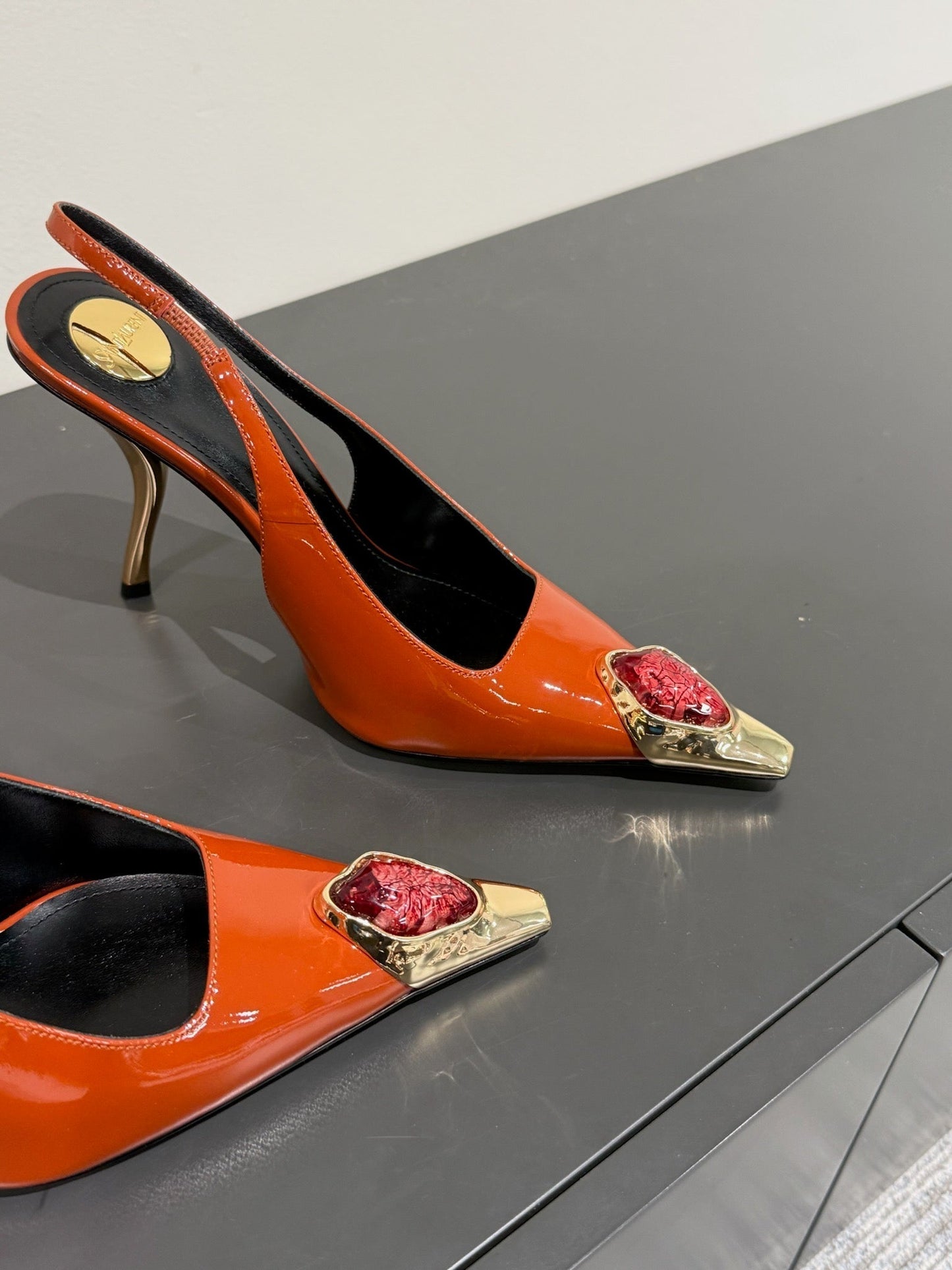 RED GEM-STUDDED SLINGBACK PUMPS IN ORANGE PATENT CALFSKIN