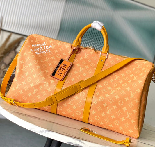 KEEPALL BANDOULIÈRE 55 IN ORANGE MONOGRAM HERITAGE CANVAS